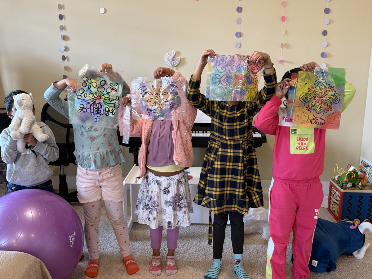 Kids holding artwork